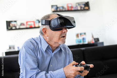 Elderly man plays soccer with virtual reality goggles