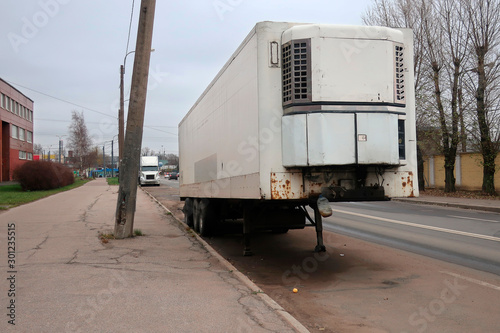 a large white freight van parked on the side of the road