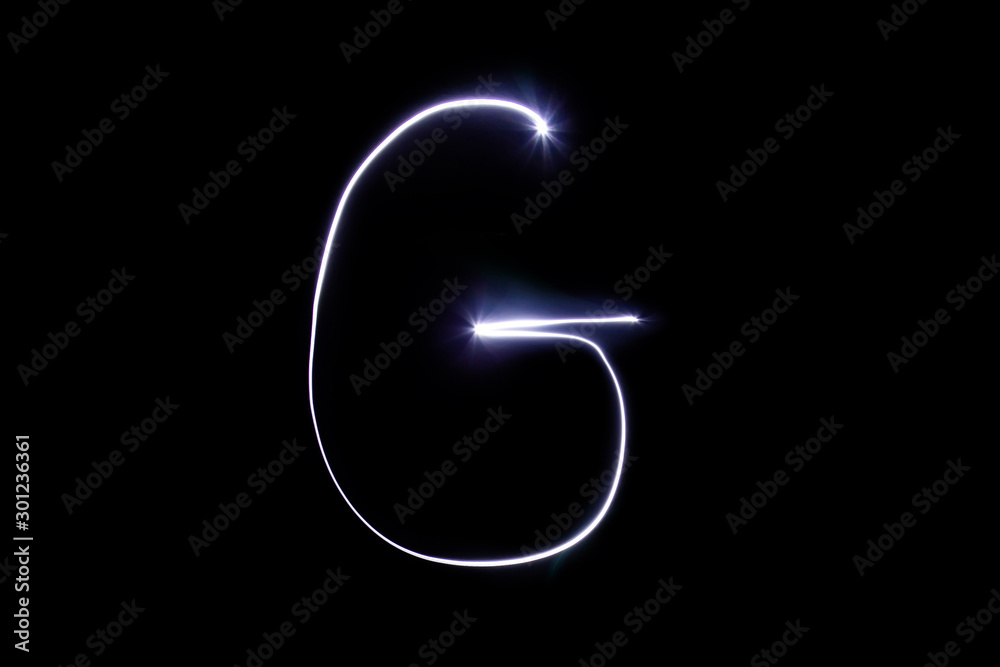 Alphabet made of neon light on a black background. Isolated top view, letter g. Alphabet made of neon light on a black background. Isolated top view, letter g.