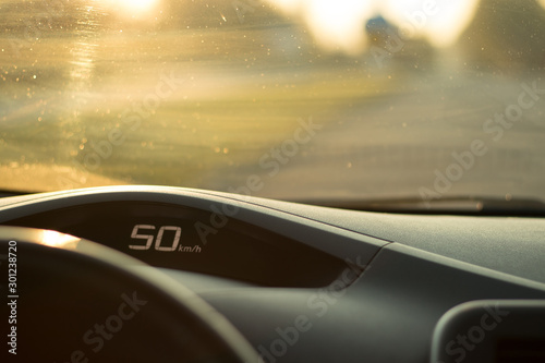 The dashboard of the car with a speed of 50 km / h on the speedometer; safe driving concept; speed limit; copy space