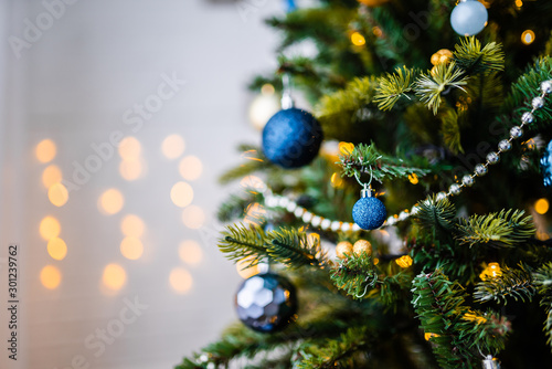 Dressed up Christmas tree. Gold and blue Christmas tree decorations for Christmas.
