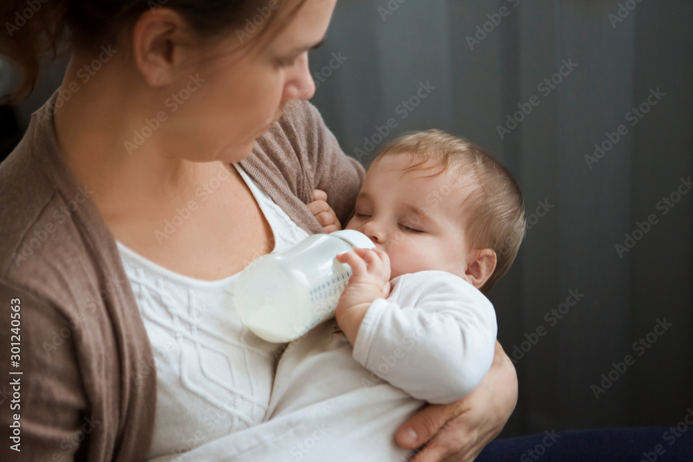 Adorable baby with a milk bottle. Baby milk eating bottle Adorable baby with a milk bottle. Baby milk eating bottle