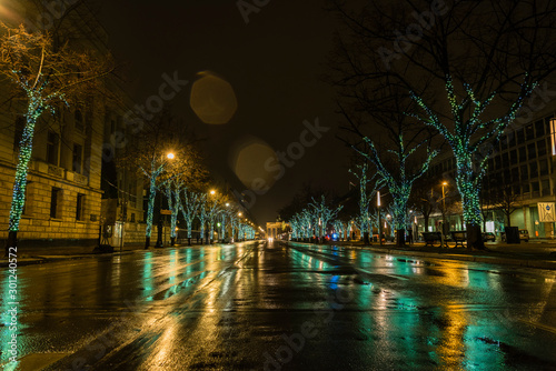 Street in Berlin at Christmas time, rainy weather, wet street, street with Christmas lights, Unter den Linden, Berlin, Lensflares, rain drops on lens
