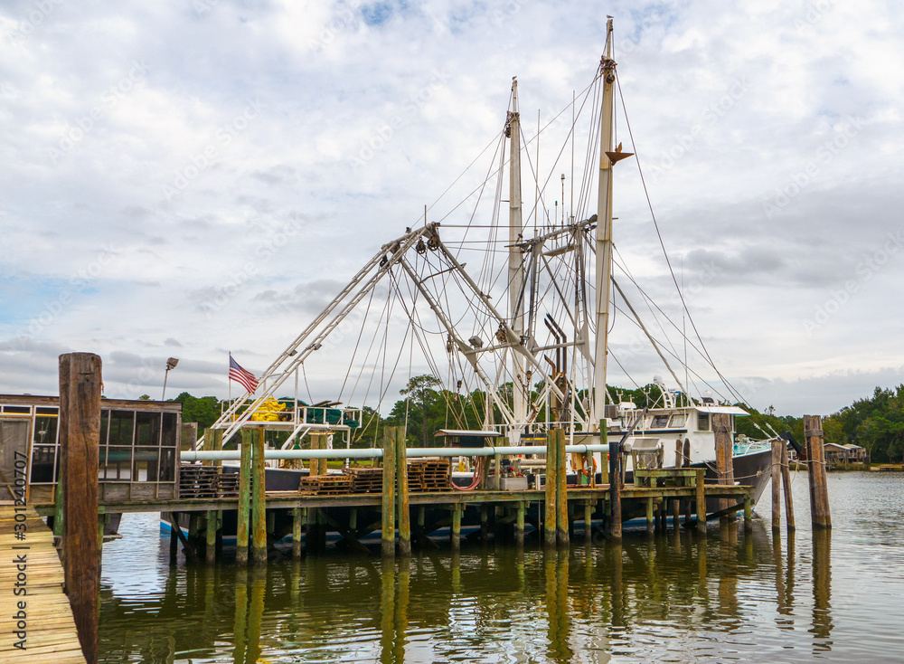 Shrimp trawler fishing boat in water at dock in Alabama USA