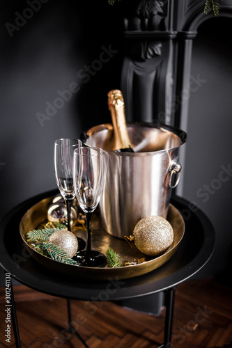 Holiday set. Champagne in a cooling bucket with glasses for couples in love.