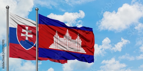 Photography Slovakia and Cambodia flag waving in the wind against white cloudy blue sky together