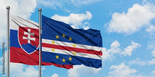 Photography Slovakia and Cape Verde flag waving in the wind against white cloudy blue sky together