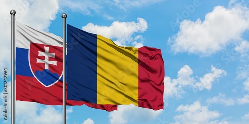Canvas Print Slovakia and Chad flag waving in the wind against white cloudy blue sky together