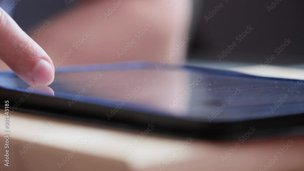 Coseup man finger touching scroll page app on tablet. Browsing a movie video in the library to watch on touchpad. FullHD 1080p video shot Coseup man finger touching scroll page app on tablet. Browsing a movie video in the library to watch on touchpad. FullHD 1080p video shot