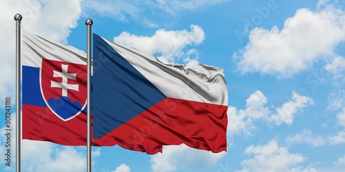 Slovakia and Czech Republic flag waving in the wind against white cloudy blue sky together. Diplomacy concept, international relations. photo