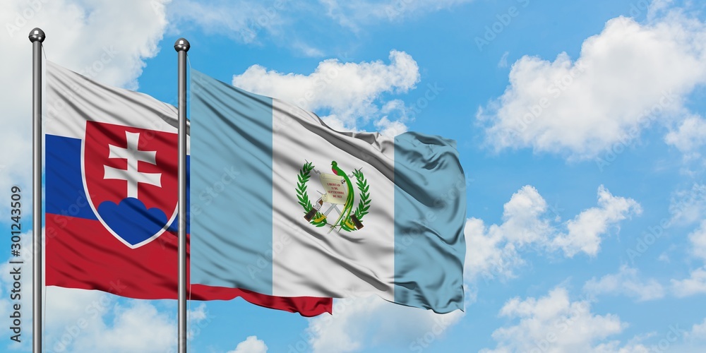 Slovakia and Guatemala flag waving in the wind against white cloudy blue sky together. Diplomacy concept, international relations.
