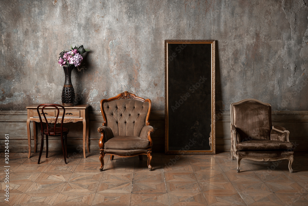old chair, a mirror and a table with flowers on background of vintage wall  Stock Photo | Adobe Stock