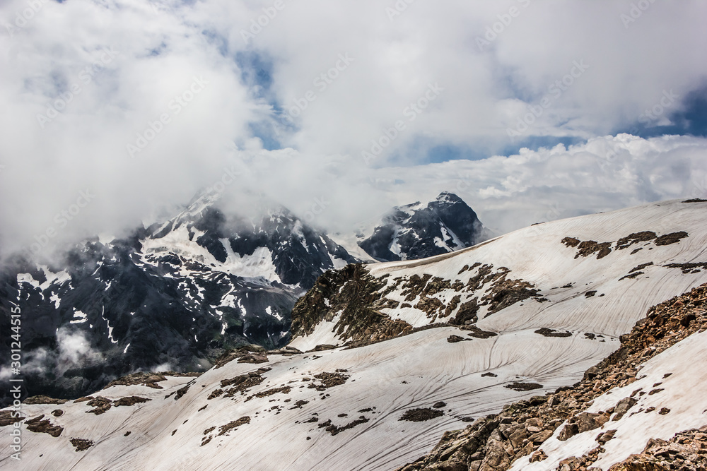 high mountains covered with snow and ice, peaks and valleys in the Caucasus