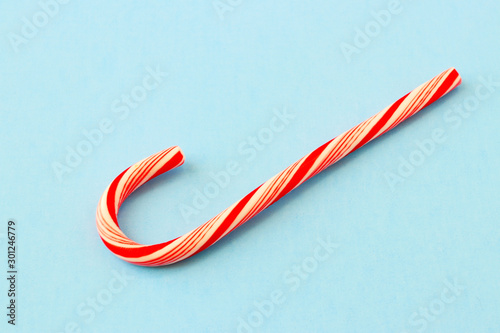 Christmas composition. Candy cane decorations on blue background. Christmas, winter, new year and holiday card.