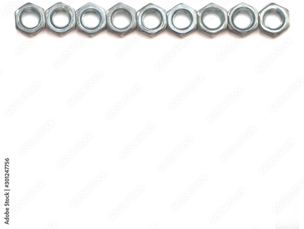 silver nuts on a white background located in a row on one side of the image. isolate.Flat lay silver nuts on a white background located in a row on one side of the image. isolate.Flat lay
