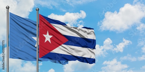 Somalia and Cuba flag waving in the wind against white cloudy blue sky together. Diplomacy concept, international relations.