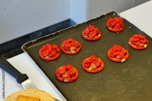 Baking berry macaron tarts at a French pastry shop photo