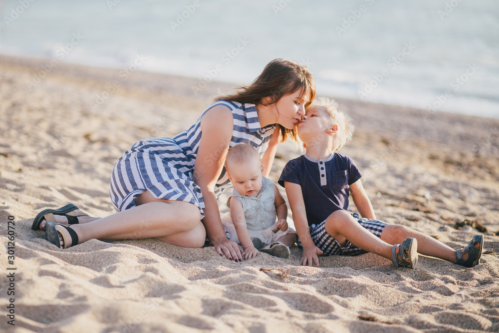 Happy mother and her children posing at beach. Happy mother and her children posing at beach.