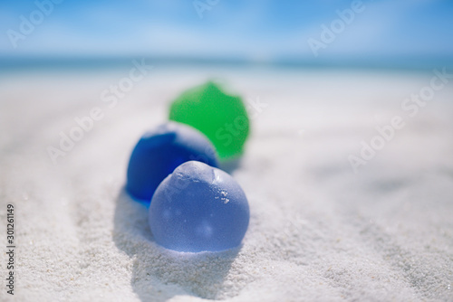sea glass on white sand beach
