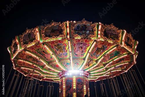 Classic carousell in vintage style during evening with dark background