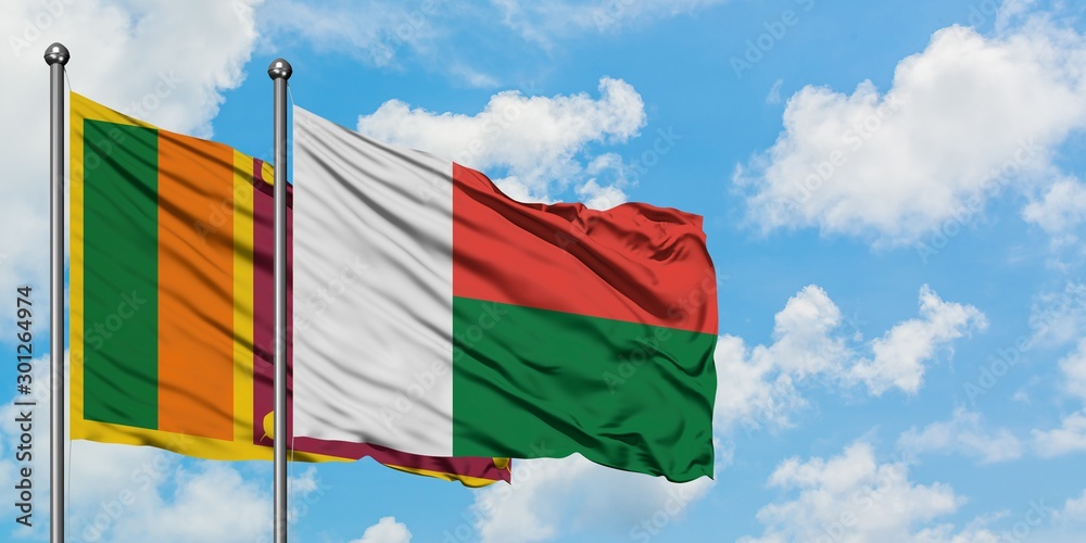 Sri Lanka and Madagascar flag waving in the wind against white cloudy ...