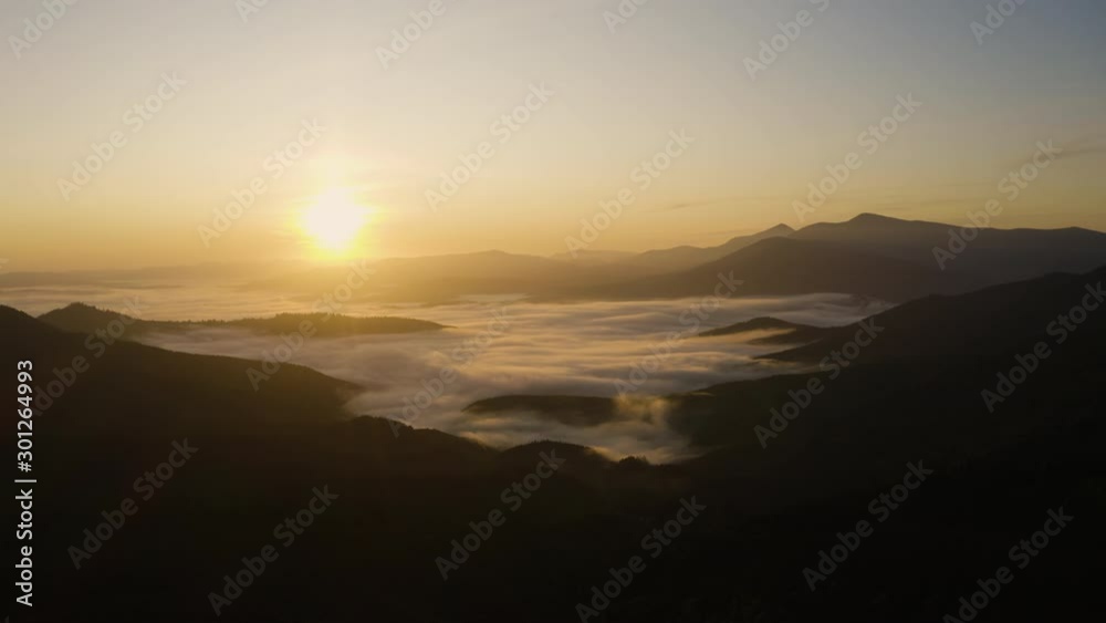 Fly over clouds in Mountain. Morning Fog at Sunrise. Aerial drone view landscape Fly over clouds in Mountain. Morning Fog at Sunrise. Aerial drone view landscape