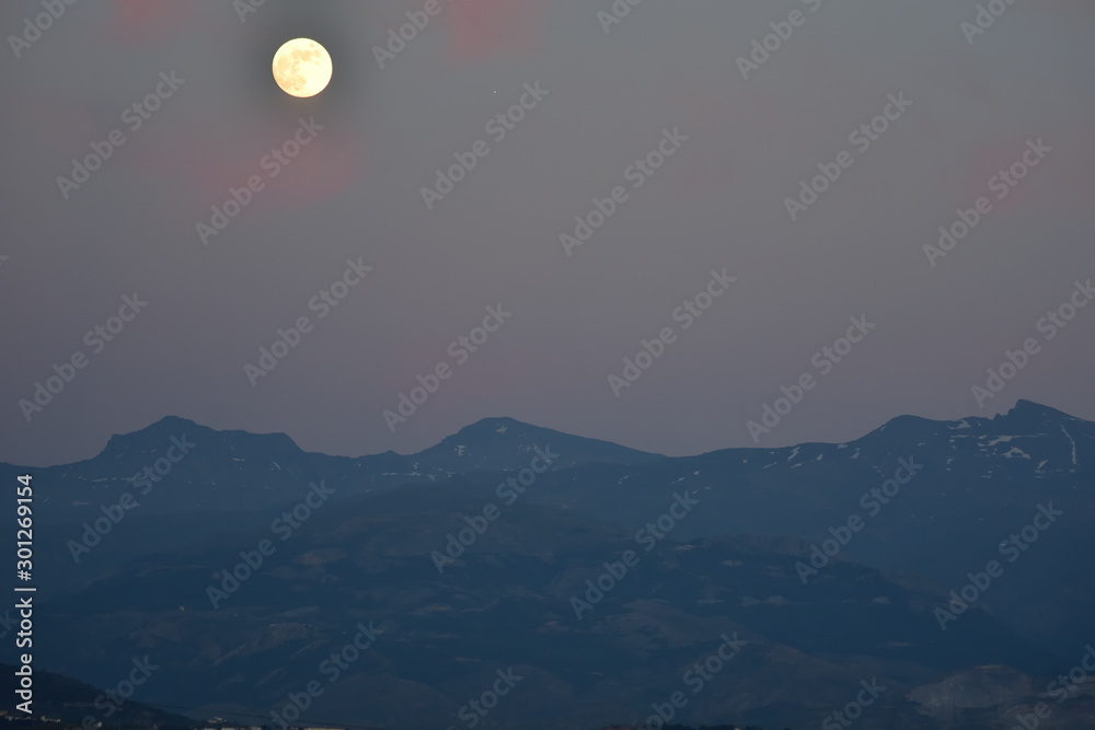 moon over mountains at evening in Sierra Nevada 