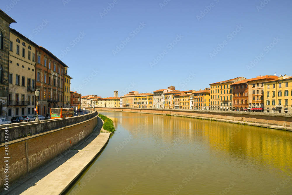 Scenic view of the Arno river from Ponte di Mezzo bridge with the ancient buildings of Lungarno Antonio Pacinotti (right) and Lungarno Galileo Galilei (left), Pisa, Tuscany, Italy