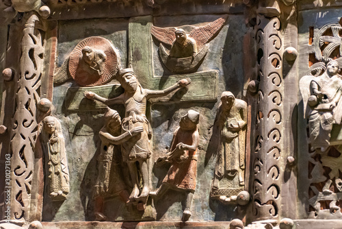 Mini statues engraved on bronze door representing Jesus´s crucifixion