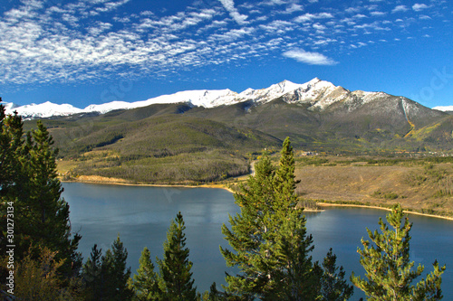 Mountain alpine lake between the snow covered peaks