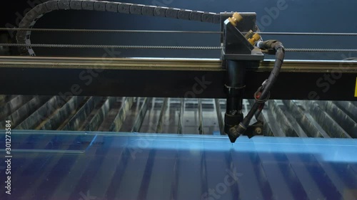 Laser cutting machine carving patterns on the plastic plate