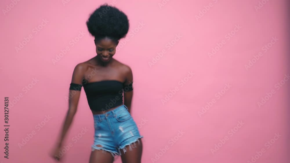Sexy Pretty Afro-american model smiling and posing pink background