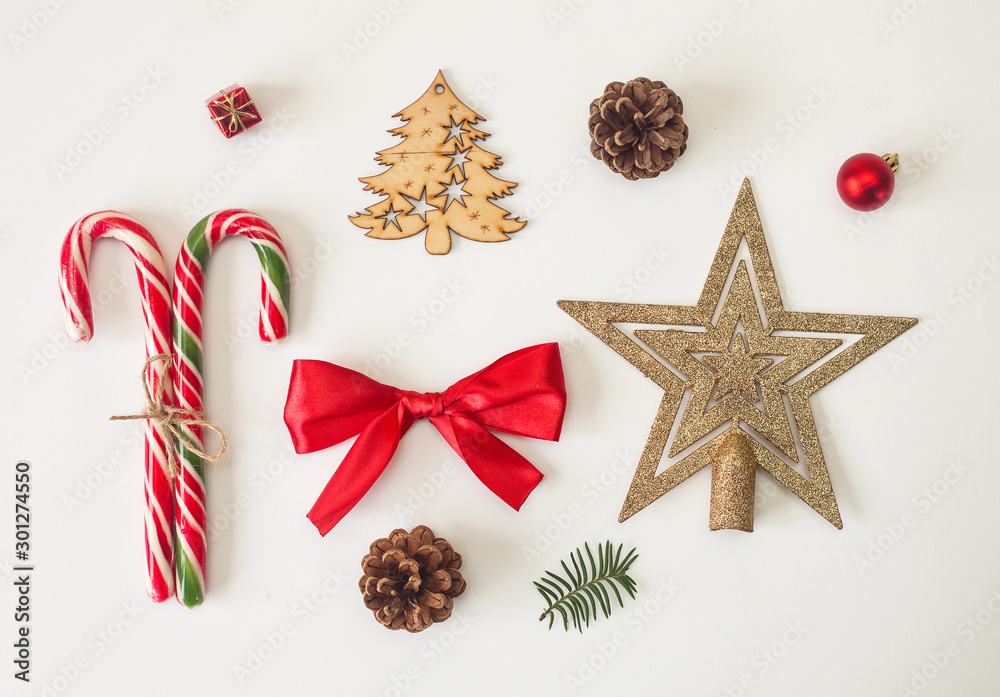 Holiday stuff, candies, ribbons, christmas decorations and pine cone on white background. Set of objects. Holiday stuff, candies, ribbons, christmas decorations and pine cone on white background. Set of objects.