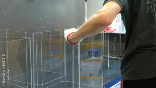 Worker sorting plastic parts and collect order