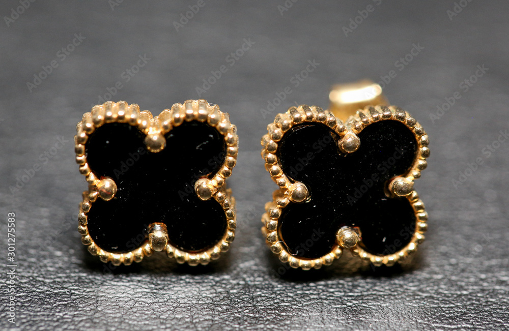 Small black clover earrings on white background. - Image Small black clover earrings on white background. - Image