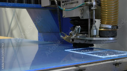 Milling cutter cuts plastic part on robotized production line. Factory robots used to produce precise an strict product on automation conveyor lines.