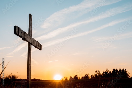 Leinwand Poster Closeup of a handmade wooden cross with a sky