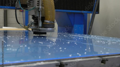 Cnc milling cutter cuts sheet of plastic on robotized production line. Factory robots used to produce precise an strict product on automation conveyor lines.