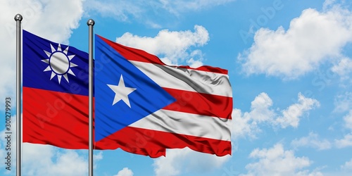 Taiwan and Puerto Rico flag waving in the wind against white cloudy blue sky together. Diplomacy concept, international relations.