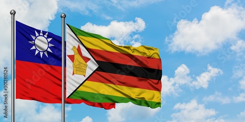 Taiwan and Zimbabwe flag waving in the wind against white cloudy blue sky together. Diplomacy concept  international relations.
