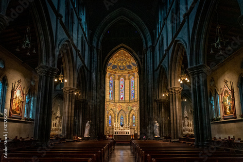 KILKENNY, IRELAND, DECEMBER 23, 2018: Interior of St. Mary's Cathedral, partly illuminated with a mixture of darkness o light, with biblical statues and nobody around.