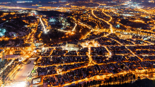 Brasov  Transylvania. Romania. Panoramic view at night of the old town and Council Square  Aerial twilight cityscape of Brasov city  Romania