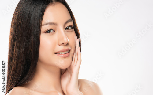 Beautiful young Asian woman touching soft cheek and smile with clean and fresh skin. Happiness and cheerful with  isolated on white background  Beauty and Cosmetics Concept 