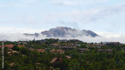 Granite Mountain clothed in clouds as morning comes to Northern Arizona photo