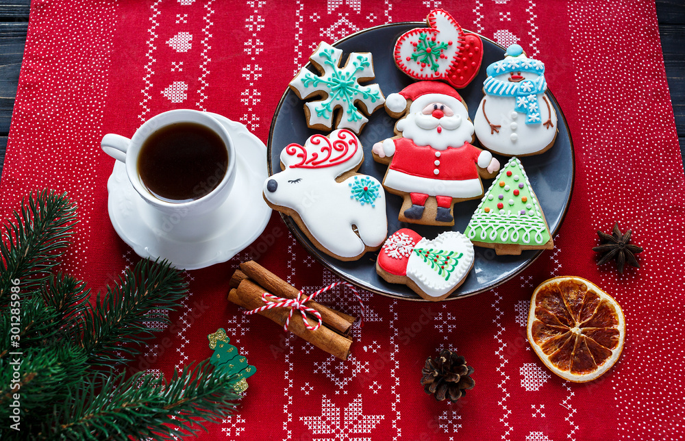 Homemade gingerbreads on plate on wooden background. Holidays and celebration concept, greeting card mockup, festive decoration. Christmas and New Year composition.