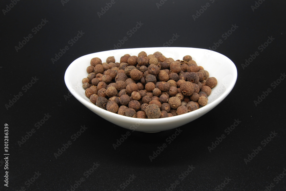 Allspice in a dish isolated Allspice in a dish isolated