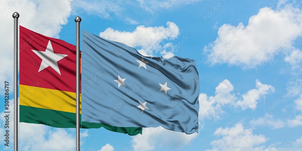 Togo and Micronesia flag waving in the wind against white cloudy blue sky together. Diplomacy concept, international relations.