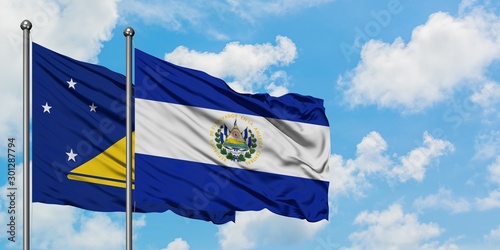 Tokelau and El Salvador flag waving in the wind against white cloudy blue sky together. Diplomacy concept, international relations.