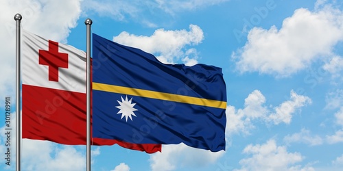 Tonga and Nauru flag waving in the wind against white cloudy blue sky together. Diplomacy concept, international relations.