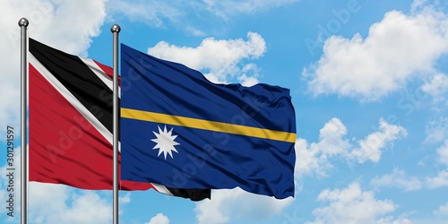 Trinidad And Tobago and Nauru flag waving in the wind against white cloudy blue sky together. Diplomacy concept, international relations.